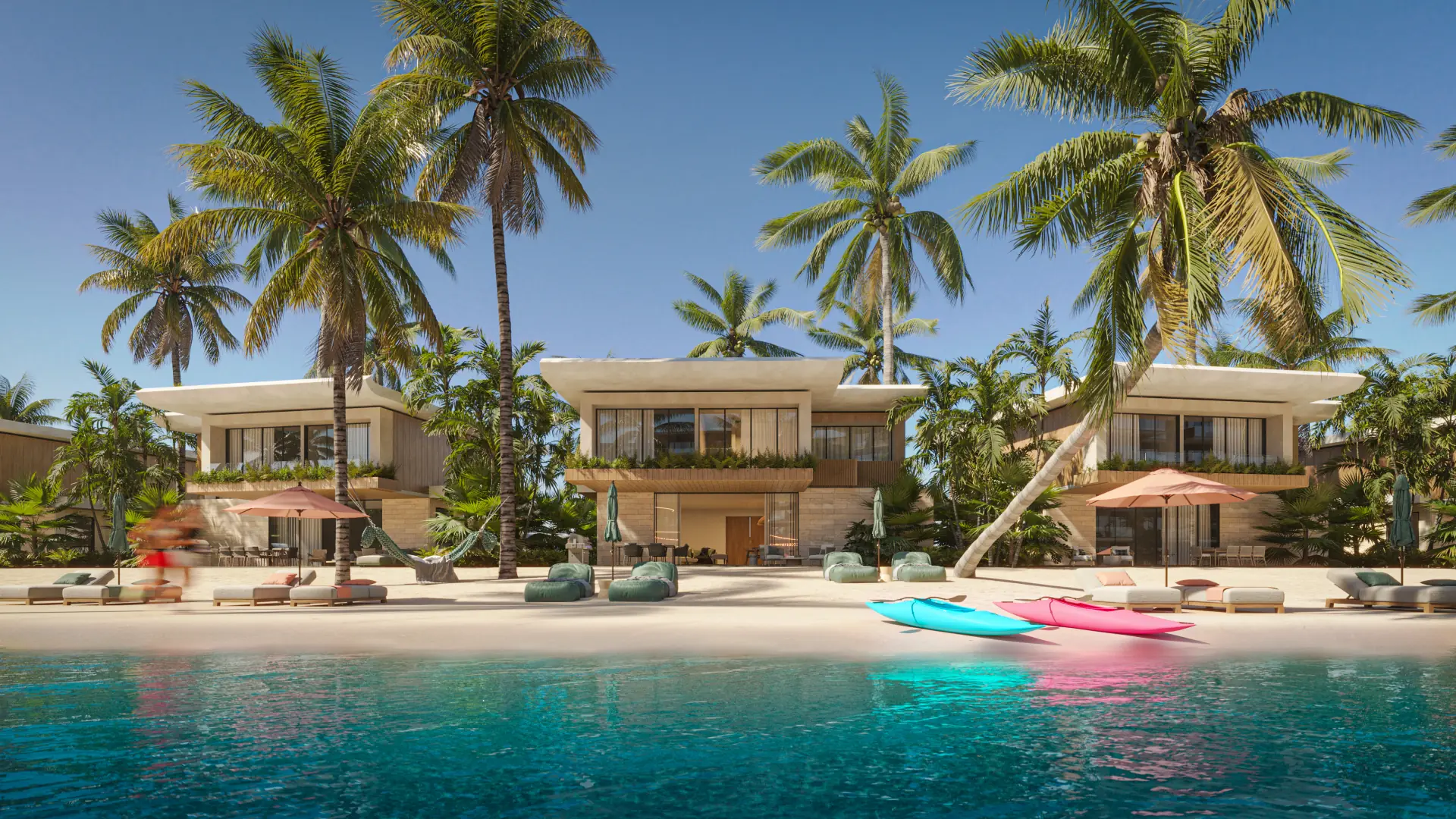 Two storey villas on the lagoon beach, palms leaning over them and kayaks at the waterline.